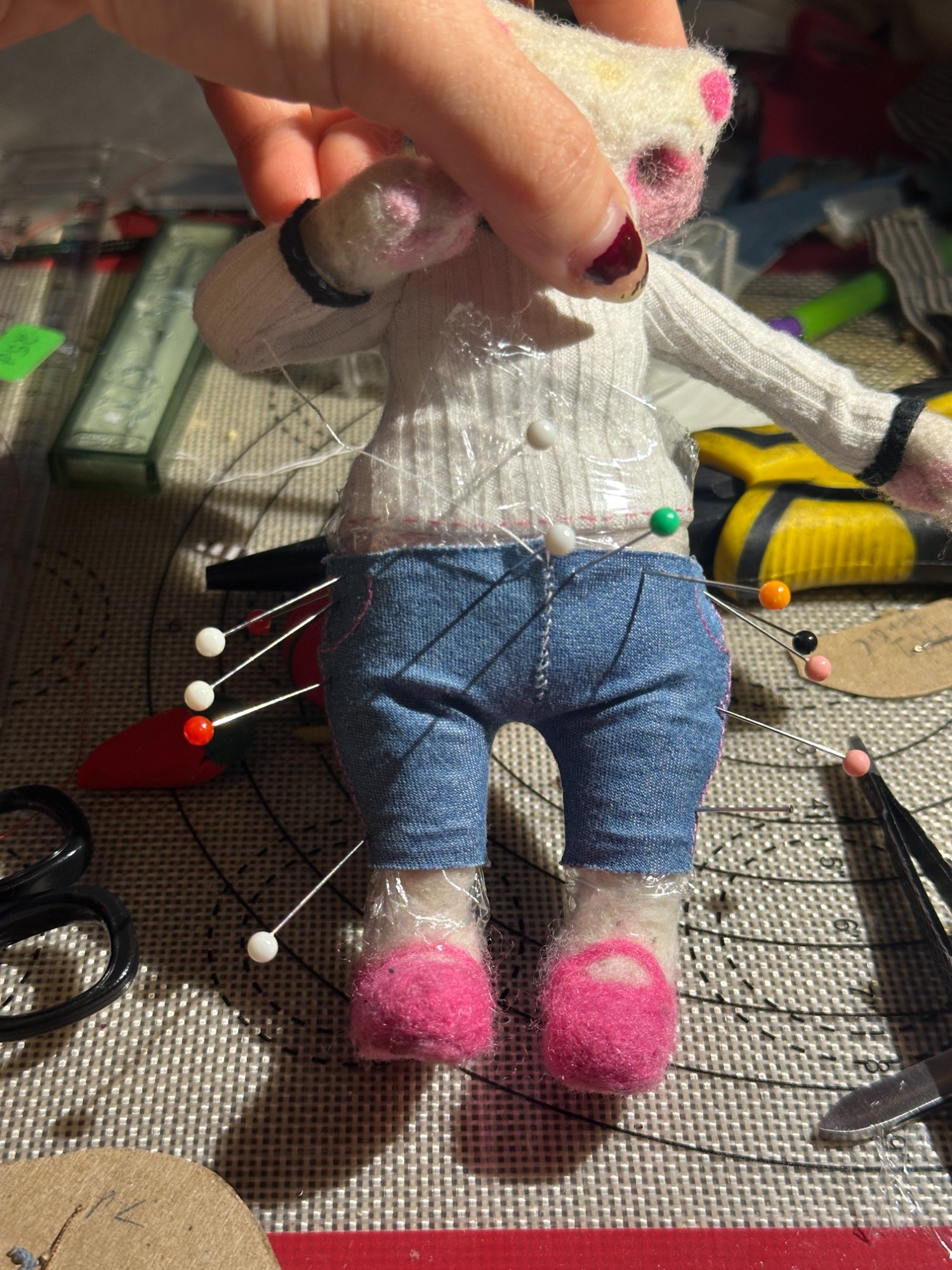 Cat maquette wearing jeans and white top